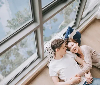 asian chinese young couple spending weekend together in living room