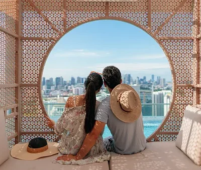 asian couple spending quiet time together in a poolside cabana while on holiday