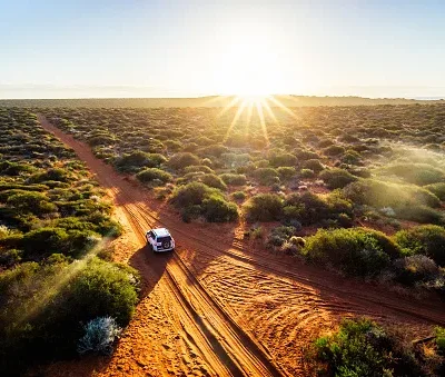 driving off road in western australia at sunset