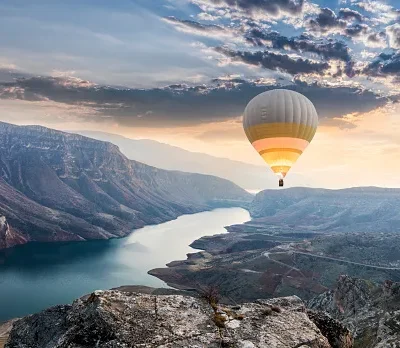 hot air balloons flying over the botan canyon in turkey