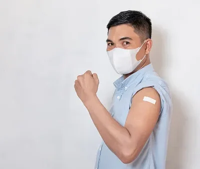 vaccinated asian adult man showing adhesive plaster bandage