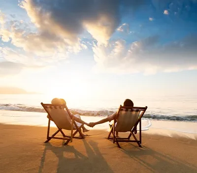 young couple sunbathing on beach chair